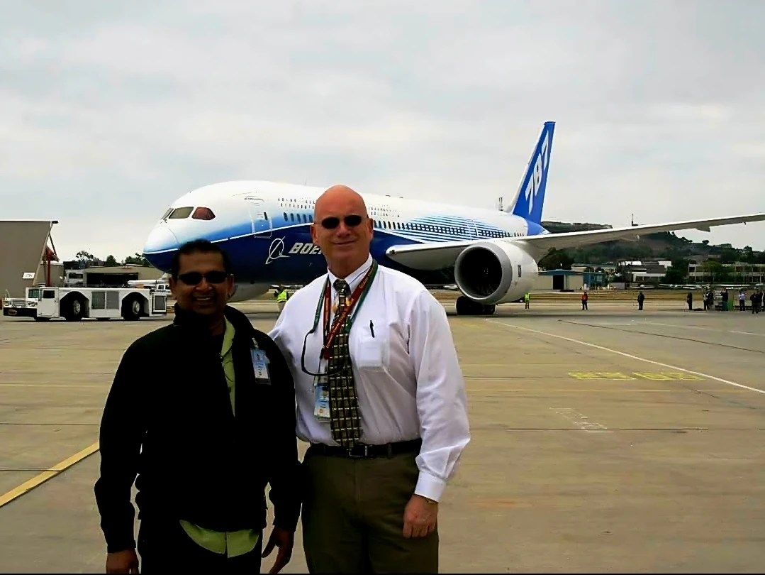 Tim Engel, SME Chapter Chair, standing with an engineer in front of a Boeing 787 Dreamliner