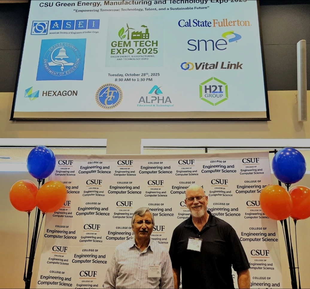 Tim Engel and Dr. Shukla at the CSU Green Energy, Manufacturing, and Technology Expo 2023 with Cal State Fullerton backdrop