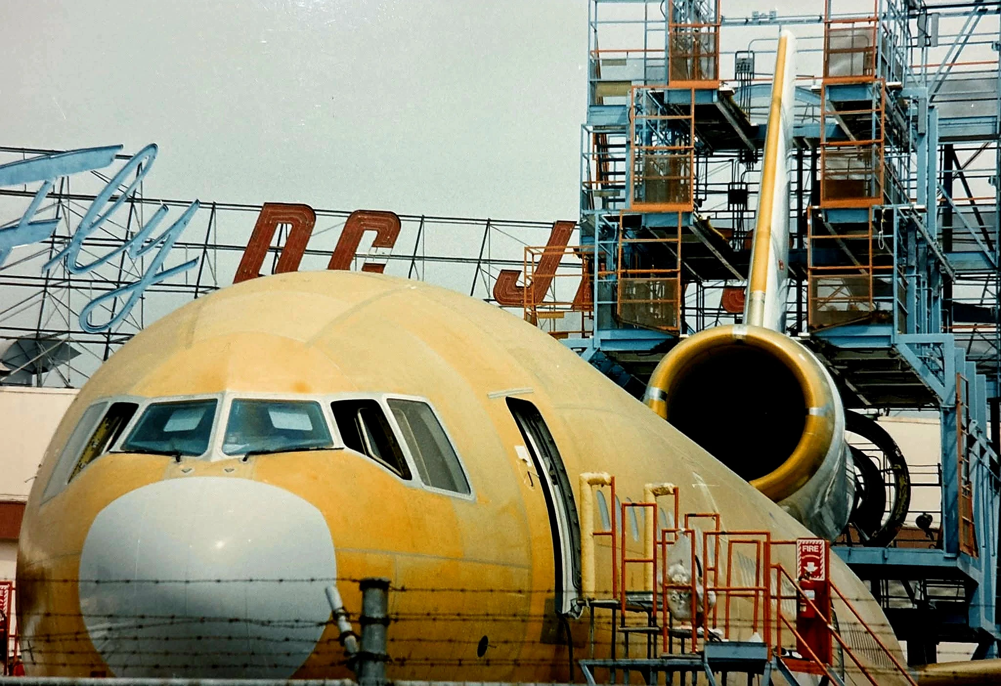 McDonnell Douglas DC-10 in maintenance hangar with scaffolding around the tail section